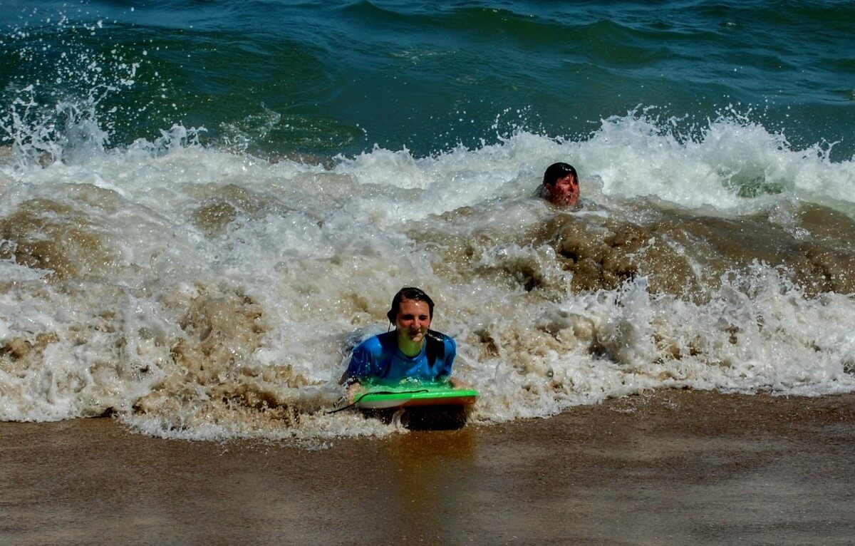 Samantha Snyder and Melissa Thornton riding the waves at the 39t Street Beach.