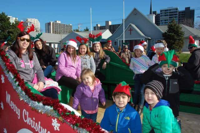 Sitting in the back of a float and waving is an important way to contribute to the Christmas Parade.