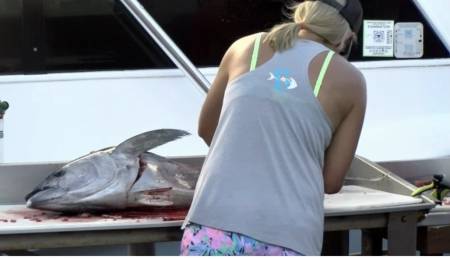 Pyle filets a fish at the marina.
