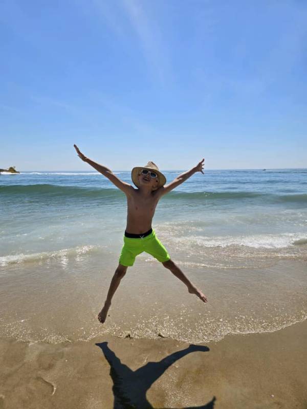 Boy jumping on the Ocean City Md beach