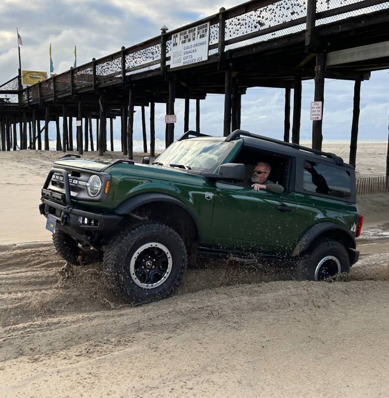 bronco in the sand under the pier in ocean city md
