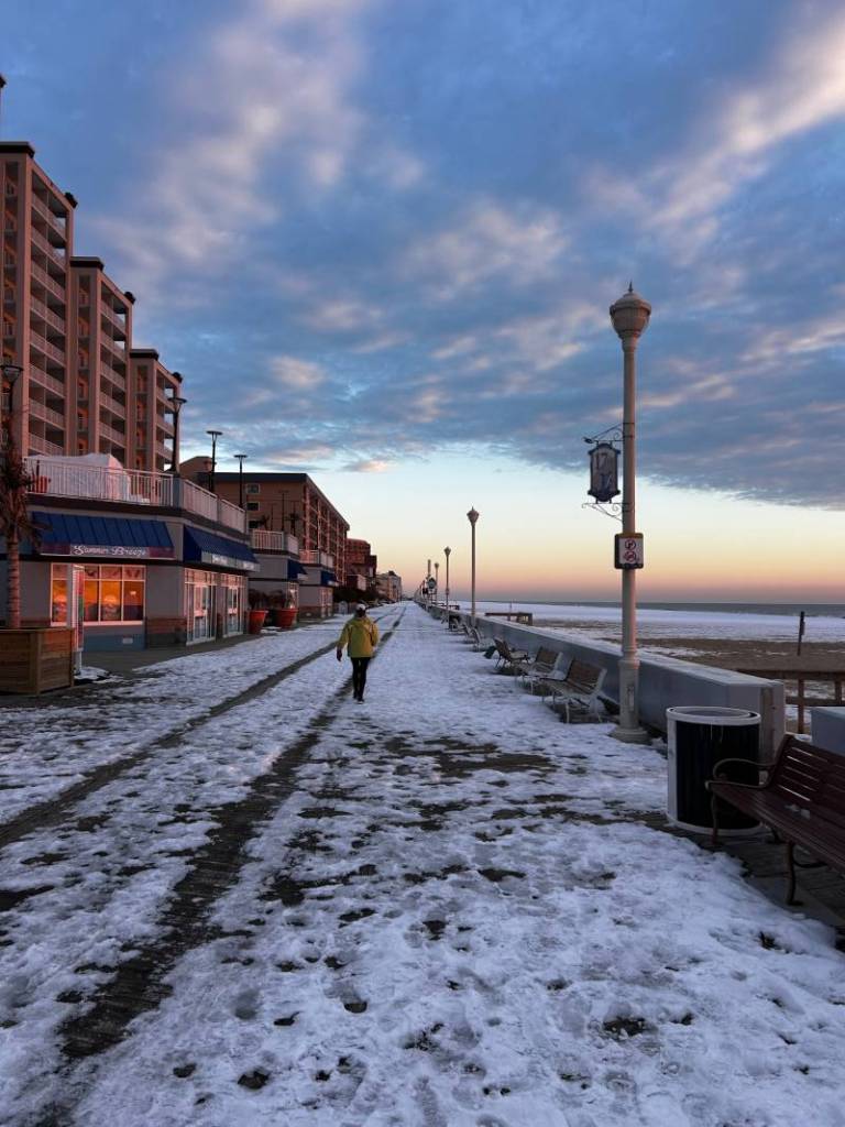lone walker on a snow OC boardwalk