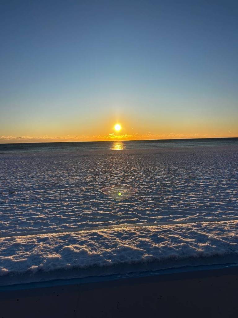 sunrise over snow beach