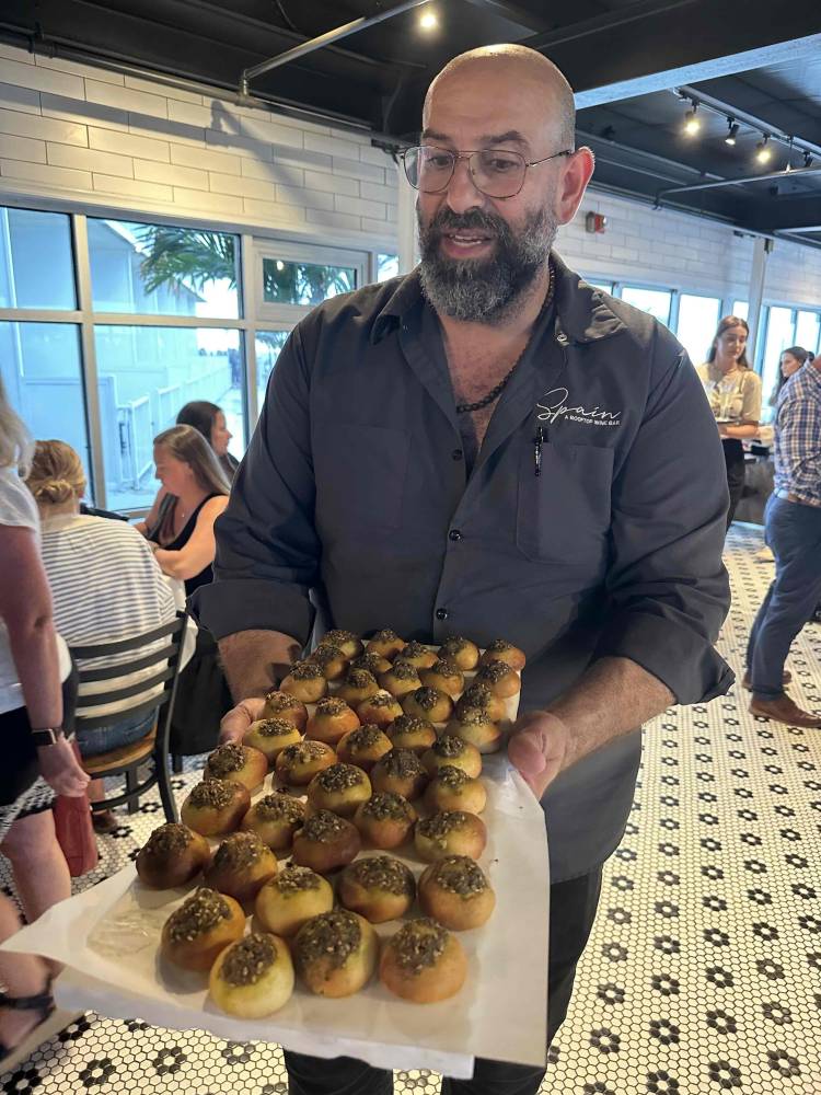 Peter Elias - owner of Bai Tee bakery offers treats to the attendees