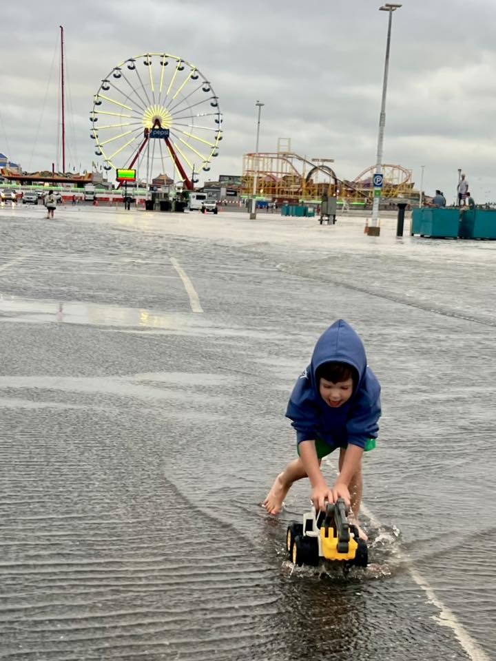 photo Friday Robin Ferralli Daniel & Digger playing at high tide during Hurricane Erin.
