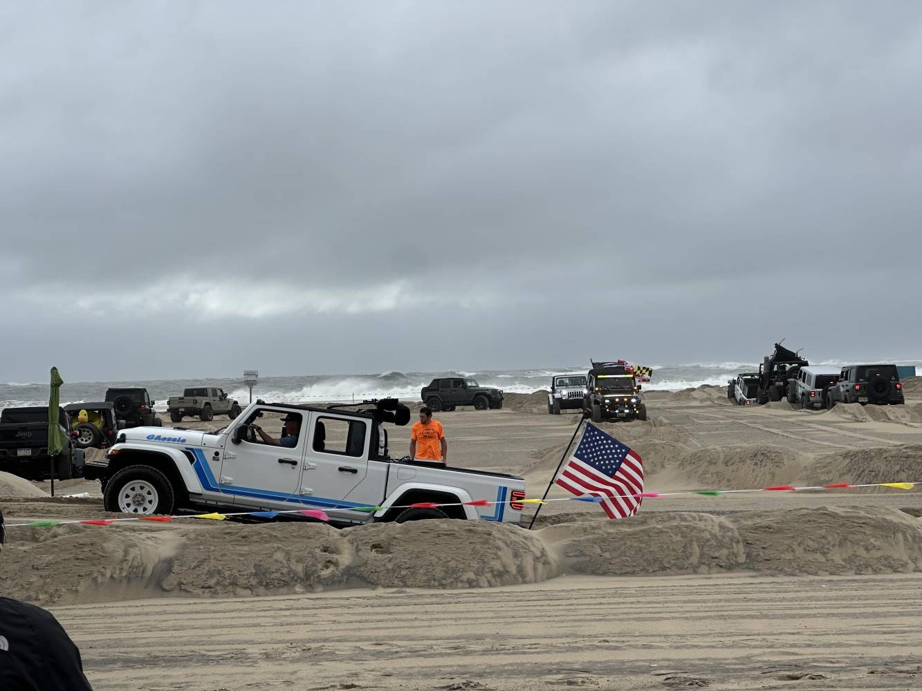 jeeps on the beach with an angry ocean in the background - jeep fest and hurricane erin coincide