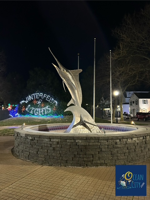 Marlin sculpture with backdrop of holiday lights