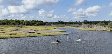 Kayakers along a fringe marsh. Photo by Rolling Wave Media
